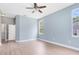 Bedroom featuring clean laminated floors, neutral paint, a ceiling fan, and natural light at 13018 S Sunset Ter, Winter Garden, FL 34787