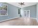 Bright bedroom featuring laminated floors, neutral paint, windows, and glass patio doors at 13018 S Sunset Ter, Winter Garden, FL 34787
