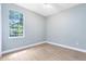 Bright bedroom featuring clean laminated floors, neutral paint, a ceiling fan, and natural light at 13018 S Sunset Ter, Winter Garden, FL 34787
