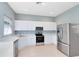 Bright kitchen with white cabinetry and stainless steel appliances at 13018 S Sunset Ter, Winter Garden, FL 34787