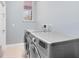 Convenient laundry room with a large washer and dryer, featuring clean, neutral paint at 13018 S Sunset Ter, Winter Garden, FL 34787