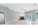 Inviting living room with a fireplace, and large windows for natural light at 13018 S Sunset Ter, Winter Garden, FL 34787
