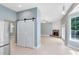 View of open floor plan with sliding barn doors, brick fireplace, and recessed lighting at 13018 S Sunset Ter, Winter Garden, FL 34787