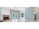 Cozy living room with a brick fireplace and French doors to the outside at 13018 S Sunset Ter, Winter Garden, FL 34787