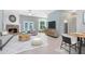 Living room with fireplace, gray sofa, rug, and nearby dining area at 13018 S Sunset Ter, Winter Garden, FL 34787
