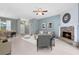 Cozy living room with fireplace, neutral furnishings, and view of the dining area at 13018 S Sunset Ter, Winter Garden, FL 34787
