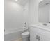 Bright bathroom featuring a shower-tub combo and modern fixtures at 1345 Griffon Ave, Lake Alfred, FL 33850