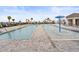 Large community pool with a splash fountain and lounge chairs, offering a refreshing oasis for relaxation and recreation at 1345 Griffon Ave, Lake Alfred, FL 33850