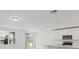 Bright kitchen with white cabinets, stainless steel appliances, quartz countertops, and natural light from large windows at 1345 Griffon Ave, Lake Alfred, FL 33850