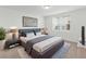 Well-lit main bedroom showcasing neutral tones, a large bed, and a window at 1345 Griffon Ave, Lake Alfred, FL 33850