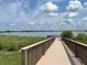 Scenic pond view from a wooden dock, featuring lush greenery and a calming water landscape at 1345 Griffon Ave, Lake Alfred, FL 33850