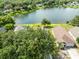 Aerial view of a home with lake access, surrounded by lush greenery and neighborhood homes at 139 Andrews Rd, Sanford, FL 32773