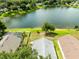 Scenic aerial shot of a house nestled by a serene lake, with mature trees and a peaceful neighborhood at 139 Andrews Rd, Sanford, FL 32773