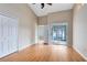 Bright bedroom with wood floors, closet, ceiling fan, and glass sliding doors to a screened enclosure at 139 Andrews Rd, Sanford, FL 32773