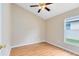 Comfortable bedroom featuring wood laminate floors, a ceiling fan, and a bright window at 139 Andrews Rd, Sanford, FL 32773
