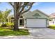Inviting single-story home featuring mature landscaping and a spacious two-car garage at 139 Andrews Rd, Sanford, FL 32773