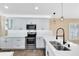 Kitchen featuring all white cabinets, subway tile backsplash, stainless steel appliances, and marble countertops at 139 Andrews Rd, Sanford, FL 32773