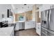 Kitchen with breakfast bar, white cabinets, stainless steel appliances, with a view to lake and backyard at 139 Andrews Rd, Sanford, FL 32773
