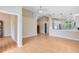 Open-concept space with wood floors connects the living area to a modern kitchen with white cabinets at 139 Andrews Rd, Sanford, FL 32773