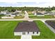 Aerial view of a modern home in a quiet neighborhood with lush landscaping and mature trees at 14915 Sw 39Th Cir, Ocala, FL 34473