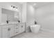 Luxurious bathroom with double sinks, a freestanding tub, and sleek fixtures with a bright, open feel at 14915 Sw 39Th Cir, Ocala, FL 34473