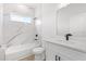 Modern bathroom with marble wall tile, soaking tub, and updated fixtures and vanity with sink at 14915 Sw 39Th Cir, Ocala, FL 34473