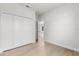 Spacious bedroom with wood floors, a large closet, and a doorway leading to other rooms at 14915 Sw 39Th Cir, Ocala, FL 34473