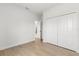Spacious bedroom with wood floors and a large closet, and a doorway leading to other rooms at 14915 Sw 39Th Cir, Ocala, FL 34473