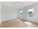 Spacious bedroom featuring wood floors and two windows offering natural light and neighborhood views at 14915 Sw 39Th Cir, Ocala, FL 34473