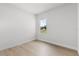 Bedroom showcasing wood floors and a bright window offering natural light and neighborhood views at 14915 Sw 39Th Cir, Ocala, FL 34473