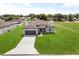 Well-maintained home featuring a two-car garage, large front yard, and long driveway at 14915 Sw 39Th Cir, Ocala, FL 34473