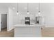 Modern kitchen with white cabinetry, a large center island, stainless steel appliances, and stylish pendant lighting at 14915 Sw 39Th Cir, Ocala, FL 34473