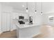 Contemporary kitchen featuring white cabinets, stainless steel appliances, and a center island with pendant lights at 14915 Sw 39Th Cir, Ocala, FL 34473