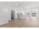 Spacious living area featuring wood flooring, a modern kitchen, and plenty of natural light at 14915 Sw 39Th Cir, Ocala, FL 34473