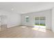 Bright living room with sliding glass doors, wood-look flooring, and access to other rooms at 14915 Sw 39Th Cir, Ocala, FL 34473