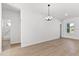 Living room area with modern chandelier, light wood floors, and light interior paint at 14915 Sw 39Th Cir, Ocala, FL 34473