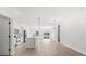 Bright open-concept living space with modern light fixtures, a kitchen island, and light wood flooring at 14915 Sw 39Th Cir, Ocala, FL 34473