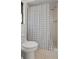 Bathroom with a patterned shower curtain, a toilet and a dark framed window at 1514 Sparrow St, Longwood, FL 32750