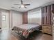 Cozy bedroom with neutral walls, wood floors, and large windows with plenty of natural light at 1514 Sparrow St, Longwood, FL 32750