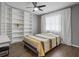 Bright bedroom with built in bookshelves, light gray walls, and wood floors at 1514 Sparrow St, Longwood, FL 32750