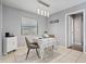 Cozy dining area with stylish light fixtures, a small table set for two, and natural light from the window at 1514 Sparrow St, Longwood, FL 32750