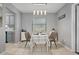 Dining area with stylish light fixtures, a small table set for two, and natural light at 1514 Sparrow St, Longwood, FL 32750