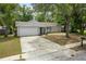Charming single-story home with a white garage and blue front door at 1514 Sparrow St, Longwood, FL 32750