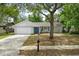 Charming single-story home featuring a well-manicured lawn, mature trees, and a cozy, inviting entrance at 1514 Sparrow St, Longwood, FL 32750