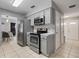 Gray kitchen with stainless steel appliances and access to the dining and entry way at 1514 Sparrow St, Longwood, FL 32750