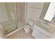 Modern bathroom with a glass-door shower, ceramic tile, and a single sink at 16129 Palm Frond Ave, Clermont, FL 34714