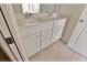 Bathroom with double vanity and white cabinets at 16129 Palm Frond Ave, Clermont, FL 34714