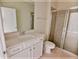 A modern bathroom with glass shower and vanity at 16129 Palm Frond Ave, Clermont, FL 34714