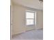 A simple bedroom with neutral carpet and a window at 16129 Palm Frond Ave, Clermont, FL 34714