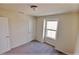 A bright bedroom with neutral carpet and a window at 16129 Palm Frond Ave, Clermont, FL 34714